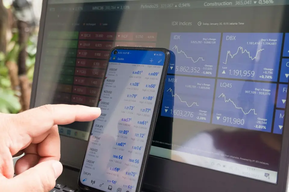 Investor reviewing markets on a phone